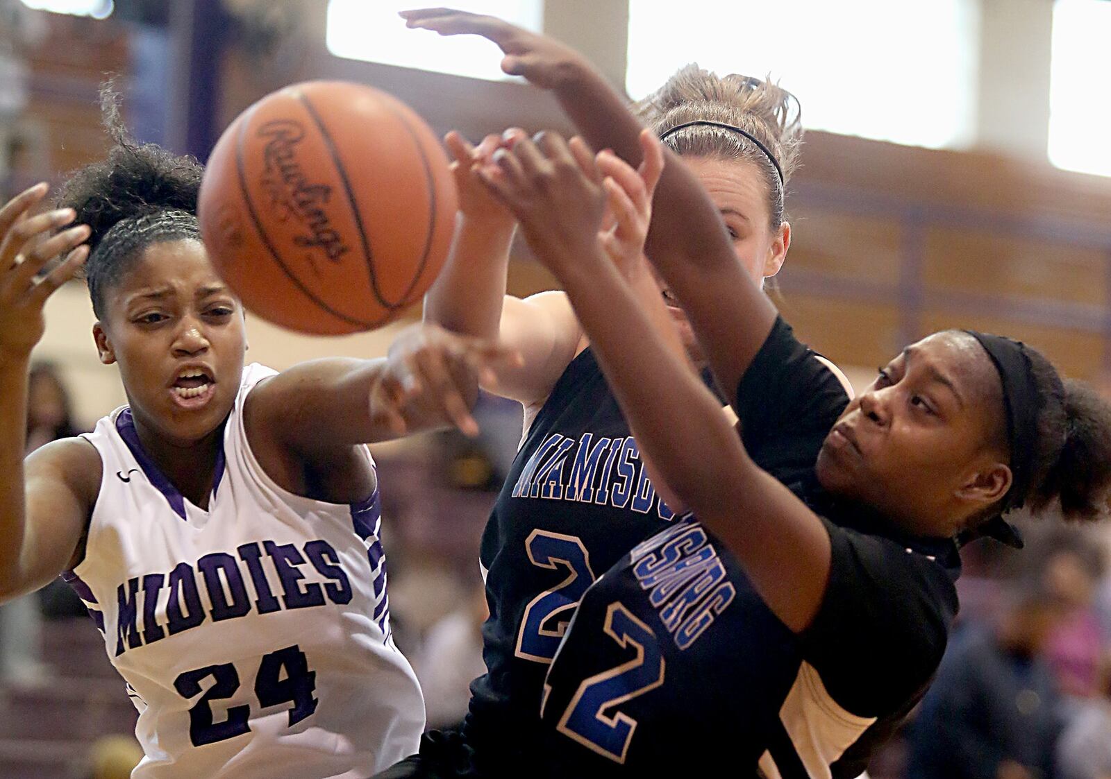 Middletown’s Olivia Wells-Daniels (24) and Miamisburg’s Emily Kepple and Aliyah Burks (right) chase a rebound during their game at Wade E. Miller Gym in Middletown on Nov. 26, 2016. Miamisburg won 49-37. CONTRIBUTED PHOTO BY E.L. HUBBARD