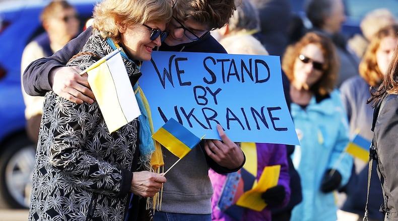 Angela Trubceac and her son, Darius Trubceac, 17, Oxford residents born in Moldova, a country that borders Ukraine, participate in a rally hosted by Oxford Citizens for Peace and Justice hosted in support of Ukraine with nearly 100 people in attendance Thursday, March 10, 2022 at Oxford Memorial Park. NICK GRAHAM/STAFF
