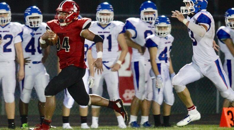 Madison’s Evan Crim sprints away from the Reading defense in a 46-0 victory Aug. 31 at Brandenburg Field in Madison Township. NICK GRAHAM/STAFF
