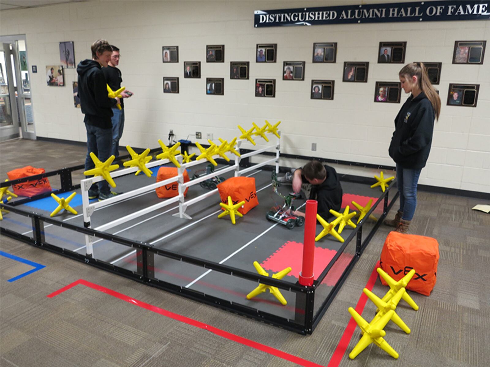 WCCC students use a robot to move pieces on a giant game board.