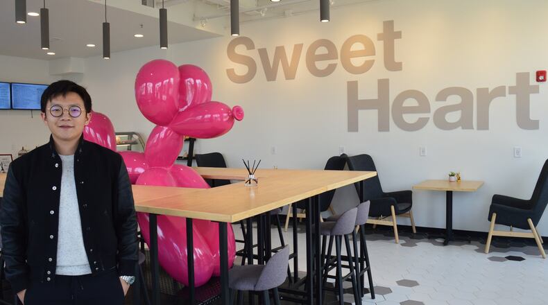Jiawei Zhu is a partner in a new business, Sweet Heart, which is a Chinese tradition offering desserts in a place where people can gather for conversation. A central table wraps around a large balloon dog. CONTRIBUTED/BOB RATTERMAN