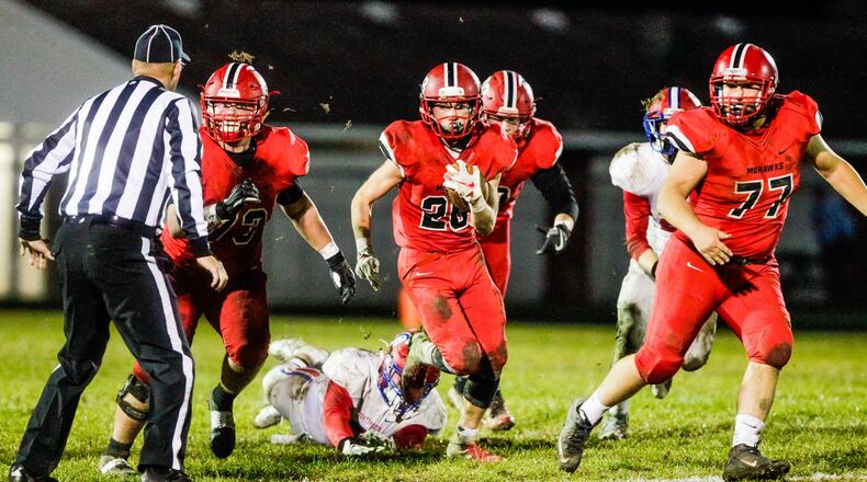 Madison’s Jake Phelps carries the ball against Portsmouth last Saturday night during a 26-0 victory in a Division V, Region 20 playoff game at Brandenburg Field in Madison Township.. NICK GRAHAM/STAFF