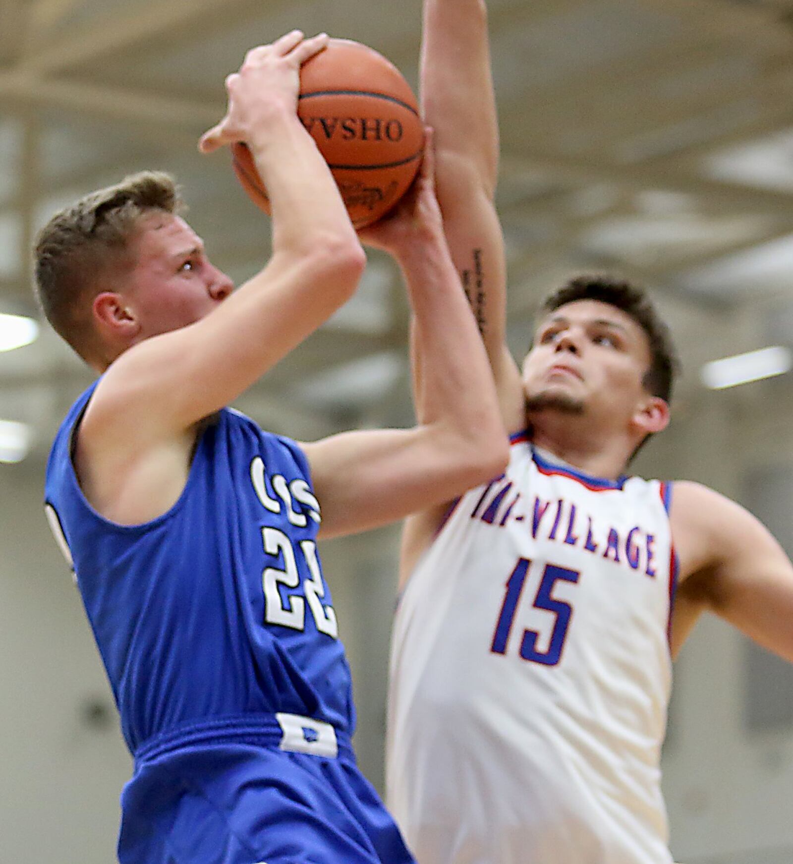 Cincinnati Christian’s Daniel Nimmo has his shot blocked by New Madison Tri-Village’s Trace Couch during their Division IV regional semifinal at Fairmont’s Trent Arena on Tuesday night. CONTRIBUTED PHOTO BY E.L. HUBBARD