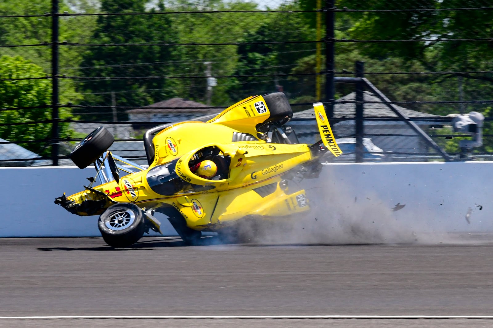 The car driven by Scott McLaughlin, of New Zealand, becomes airborne after hitting the wall in the second turn during practice for the Indianapolis 500 auto race at Indianapolis Motor Speedway in Indianapolis, Sunday, May 18, 2025. (AP Photo/John Maxwell)