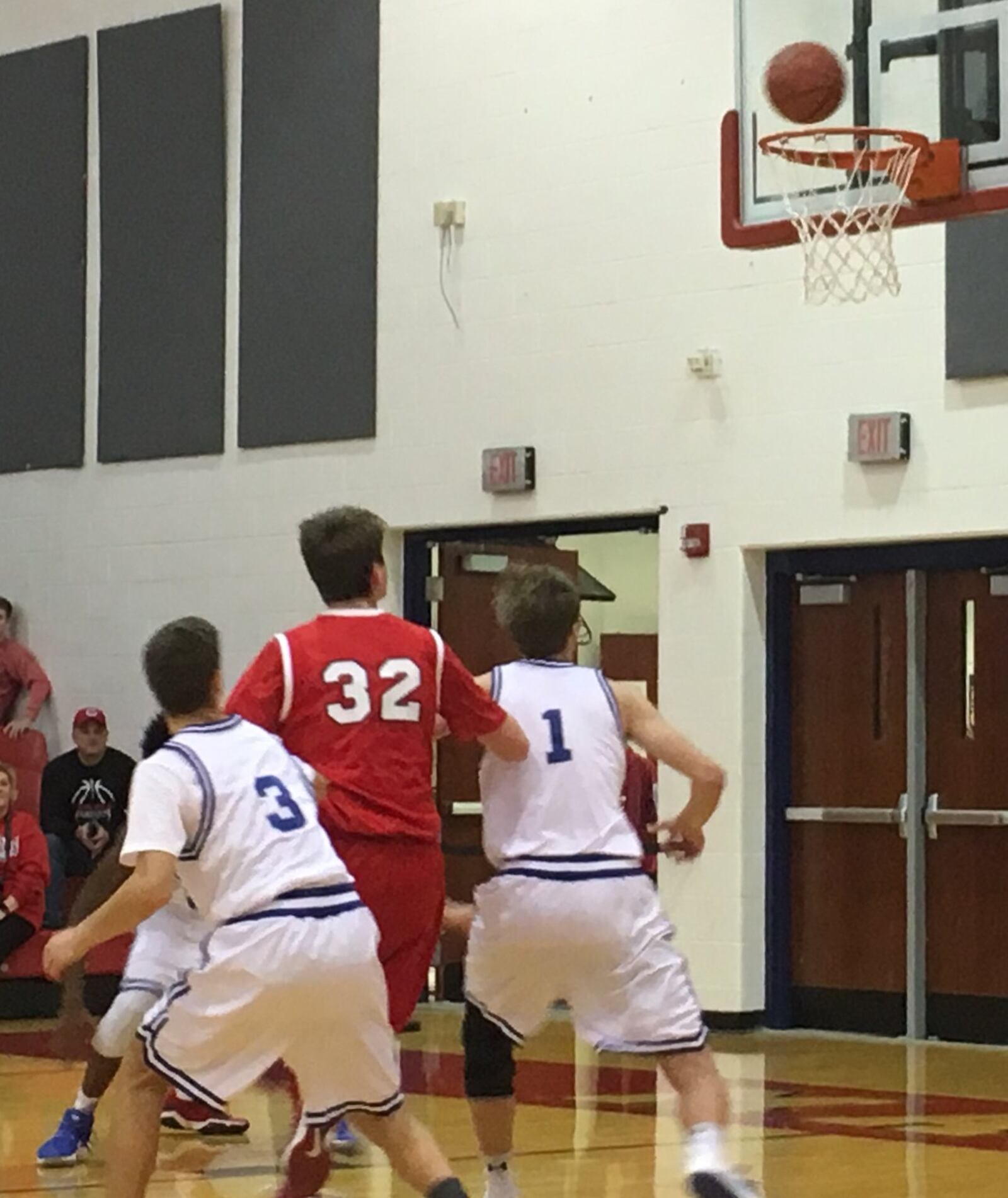 Cincinnati Christian’s Riley Reutener (1) and Johnny Nimmo (3) surround Madison’s Grant Whisman (32) as they all eye a possible rebound Thursday night during the Brian Cook Classic at Madison. The host Mohawks advanced with a 60-56 win. RICK CASSANO/STAFF