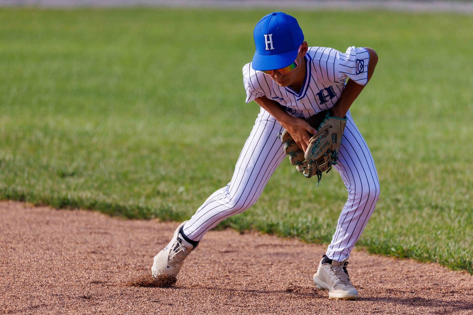 West Side's Boone Treadway fields a ground ball during his Ohio Little League District 9 tournament game against Loveland on Tuesday at West Side Little League. West Side won 14-0. TOM PATE / CONTRIBUTED