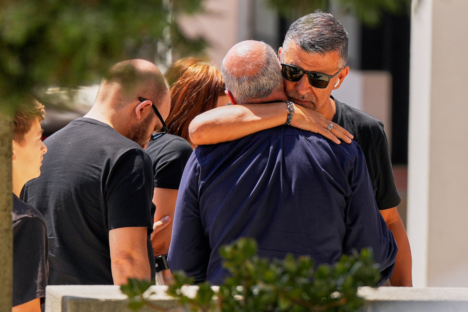 Joaquim, center, father of Liverpool forward Diogo Jota and his brother, is embraced at a church where their bodies have been brought for a wake and funeral, in Gondomar, near Porto, Portugal, on Friday, July 4, 2025. (AP Photo/Manu Fernandez)