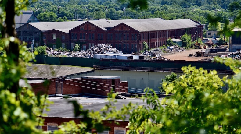 The large Cohen Recycling property directly across the Black Street Bridge from Spooky Nook Sports Champion Mill, still actively used by Cohen, may someday be redeveloped for uses that take advantage of the need for such things as restaurants, bars, hotels or other commercial uses that complement the gigantic indoor sports complex and convention center being built across the Great Miami River. NICK GRAHAM/STAFF