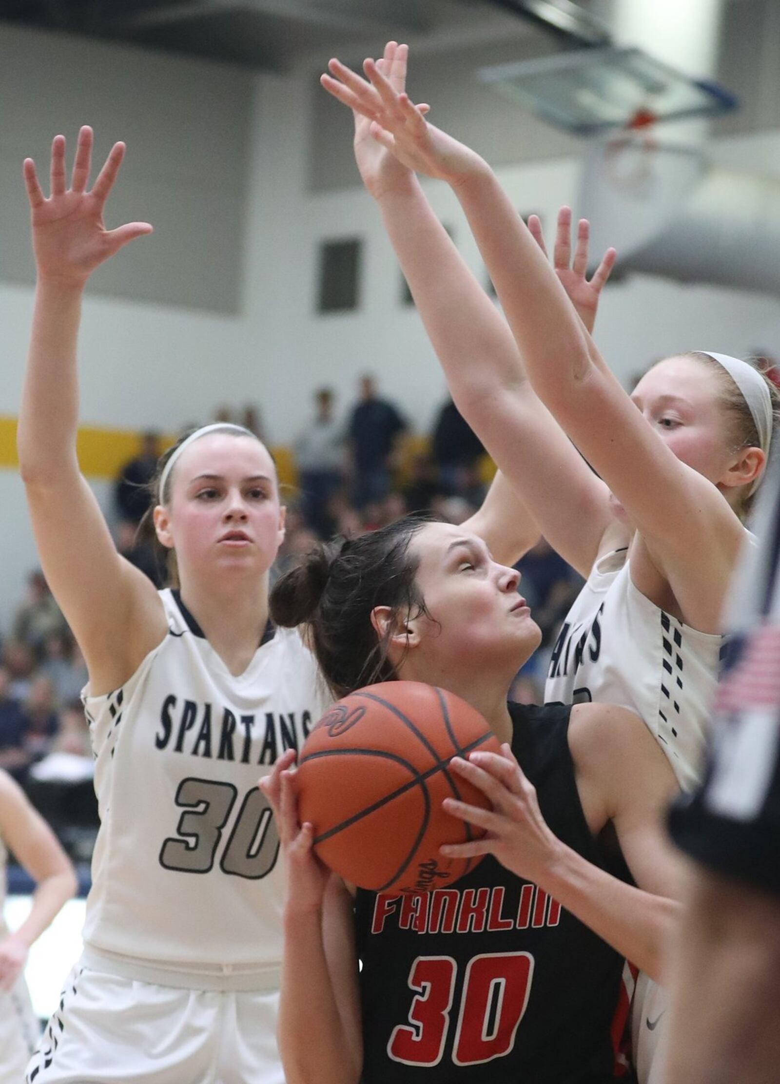 Franklin’s Layne Ferrell looks for an opening as she is surrounded by Valley View’s Claire Henson (30) and Aubrey Stupp during Tuesday night’s Division II regional semifinal at Springfield. Franklin won 47-39 in overtime. BILL LACKEY/STAFF