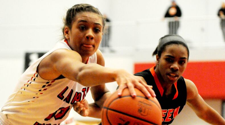 Lakota West’s Sarah Jones (left) steals the ball during the first half of the Firebirds’ 53-50 Division I district championship win over Beavercreek at Princeton on March 4, 2017. CONTRIBUTED PHOTO BY DAVID A. MOODIE