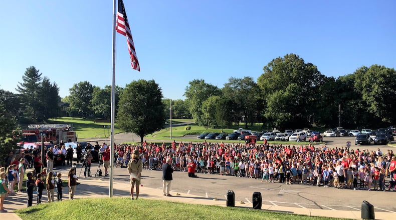 In one of the largest area school ceremonies Friday hundreds of Fairfield students saw the unveiling of a new American flag in front of their school as part of an annual 9/11 commemorative ceremony. But, befitting the solemn nature of Sunday’s anniversary of the largest terrorist attack on America, Fairfield South Elementary’s new flag was hoisted only halfway up the school’s flag pole to honor the nearly three thousand citizens and New York City first responders killed on Sept. 11, 2001. (Photo By Michael D. Clark\Journal-News)