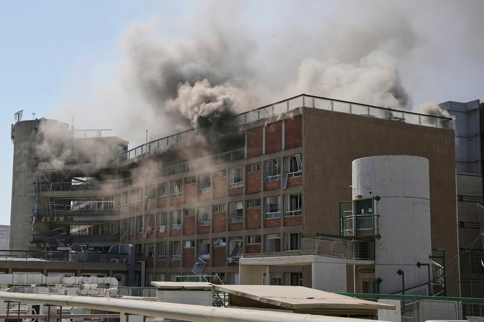 Smokes raises from a building of the Soroka hospital complex after it was hit by a missile fired from Iran in Be'er Sheva, Israel, Thursday, June 19, 2025. (AP Photo/Leo Correa)
