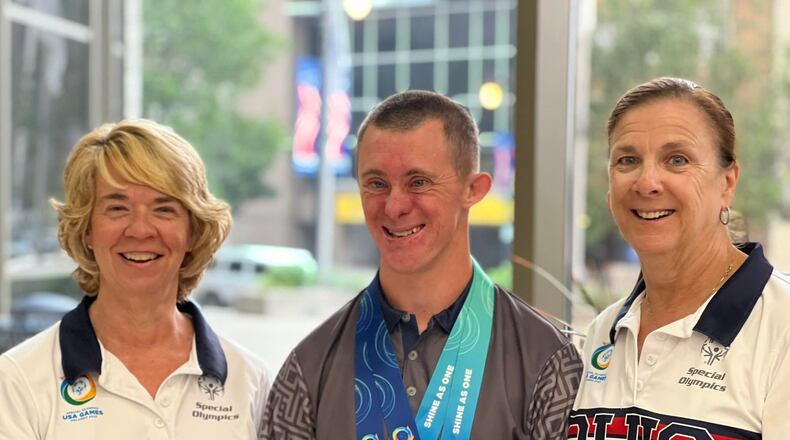 Adam Gibbemeyer, a Butler County Special Olympian who won two bocce medals in the 2022 USA Games, is joined by Tonja Pohlman, left, area coordinator of the Butler County Special Olympics, and Debbie Williams, district coordinator for Southwest Ohio Special Olympics. PHOTO BY ERICA BOWLING/CONTRIBUTED