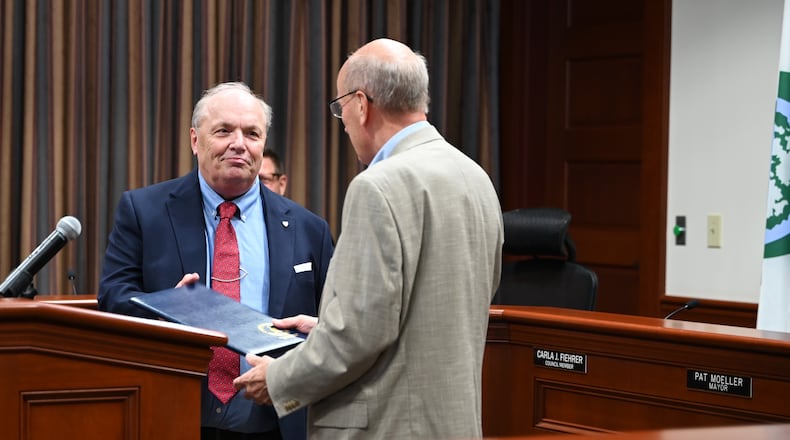 John Guggenbiller, the retired president of ODW Logistics’ transportation division, was the inaugural inductee of the Greater Hamilton Chamber of Commerce Business Hall of Fame. The ceremony was held on Thursday, June 28, 2024, inside Hamilton City Council chambers. He's pictured with Mayor Pat Moeller, who honored Guggenbiller with a proclamation. MICHAEL D. PITMAN/STAFF