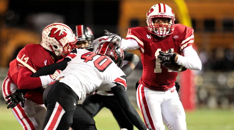 Lakota West’s Jarin Higginbotham (11) runs the ball during a game against visiting Oak Hills on Oct. 25, 2013. COX MEDIA FILE PHOTO