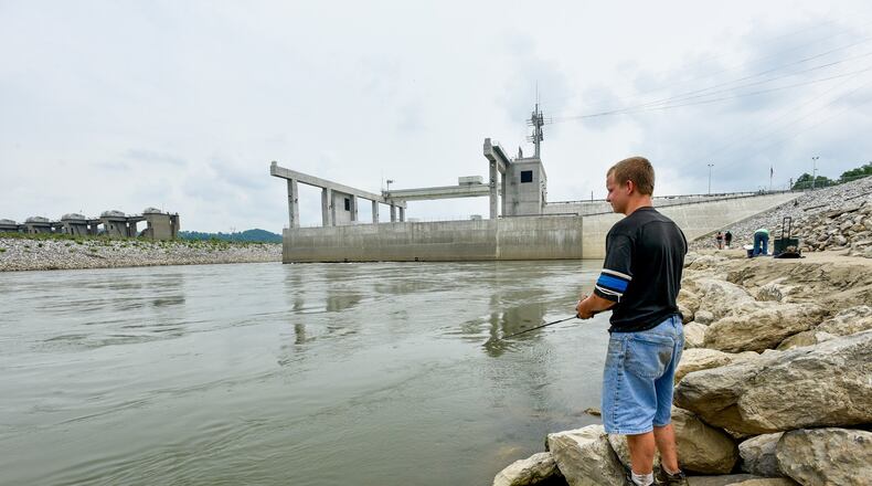 The city of Hamilton owns three hydroelectric power plants, including the 105-megawatt Meldahl Hydroelectric Plant near Foster, Ky., where Brandon Blackburn, 17, fished during its 2016 dedication ceremony. Now, Hamilton is allowing residential customers to use solar power and sell it to the city’s electric system. NICK GRAHAM/STAFF