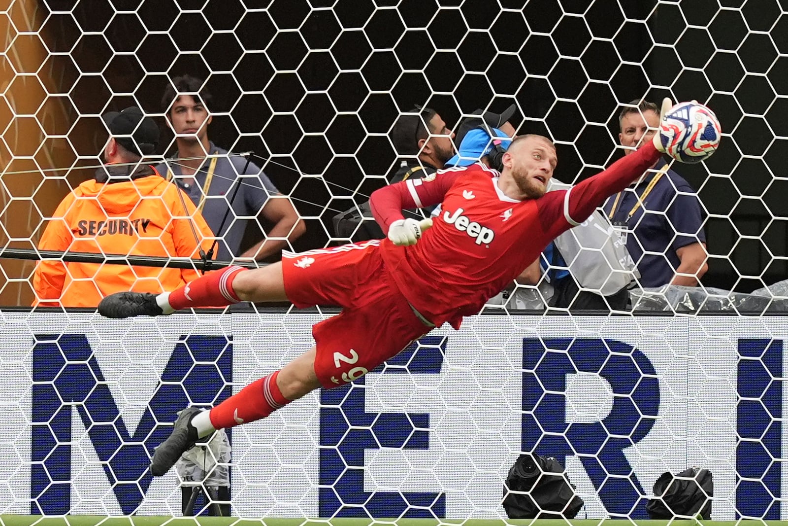 Juventus' Michele Di Gregorio saves during the Club World Cup round of 16 soccer match between Real Madrid and Juventus in Miami Gardens, Fla., Tuesday, July 1, 2025. (AP Photo/Rebecca Blackwell)