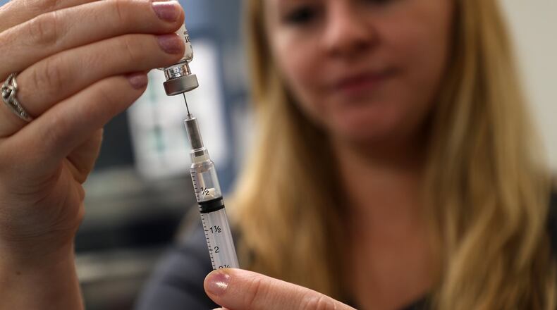 Alicia Sehen, a RN at the Clark County Combined Health Disitrict, draws up a MMR vaccine Thursday. BILL LACKEY/STAFF