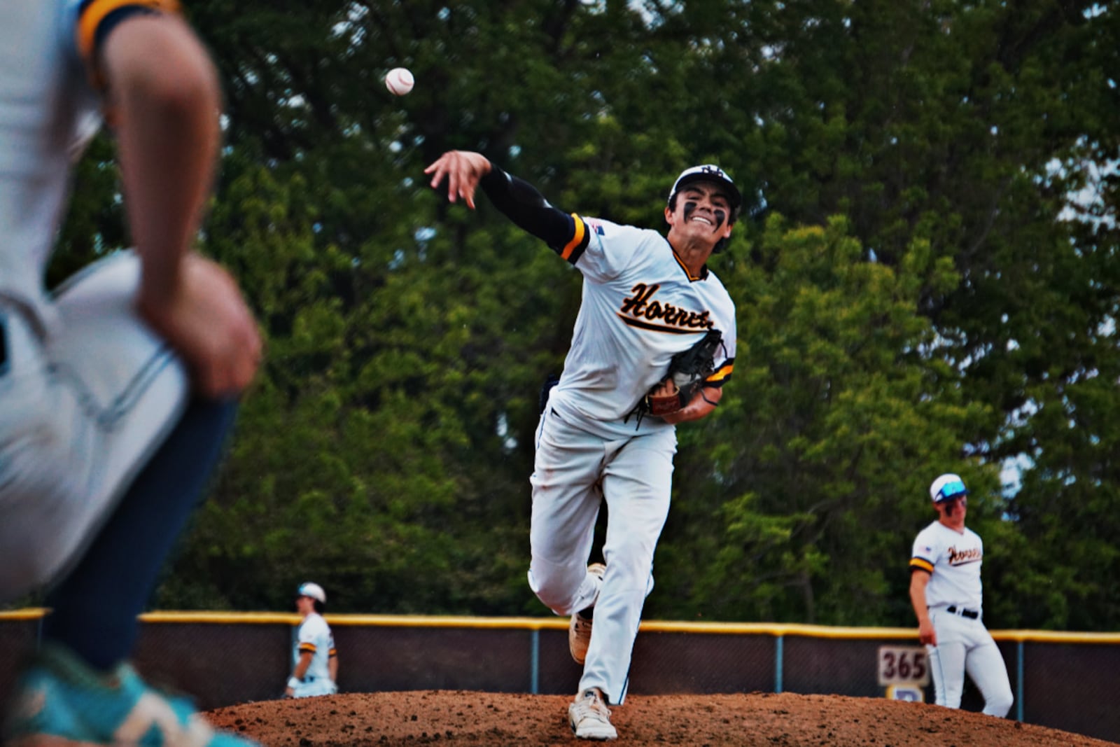 Monroe junior Dawson Watts sends a practice pitch to the plate during his game against host Ross on Monday. CHRIS VOGT / CONTRIBUTED