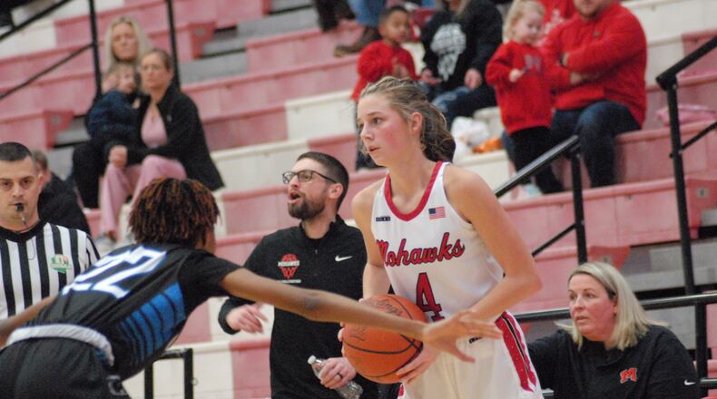 Madison junior Emily Webb (4) is guarded by Clark Montessori junior Karrington Thomas (22) during their Division III sectional contest on Thursday night at Fairfield Arena. Chris Vogt/CONTRIBUTED