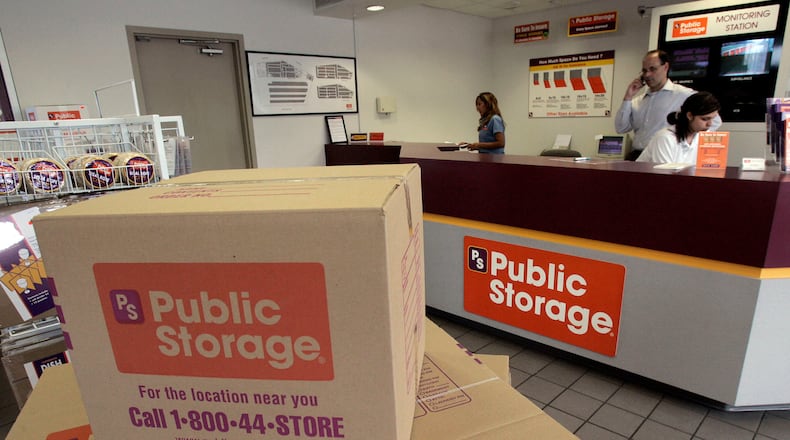 FILE - Carol Avalos, far left, Wes Demory, center, and Desiree Mora working at the customer service desk for Public Storage, Inc. on March 7, 2006, in the Eagle Rock section of Los Angeles. (AP Photo/Ric Francis, File)