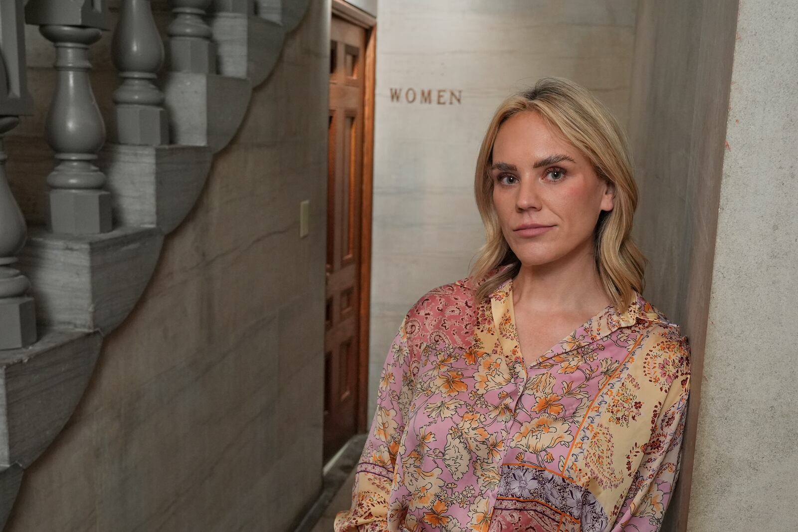 State Rep. Aftyn Behn, D-Nashville, poses outside a women's bathroom at the state Capitol, Wednesday, July 23, 2025, in Nashville, Tenn. (AP Photo/George Walker IV)