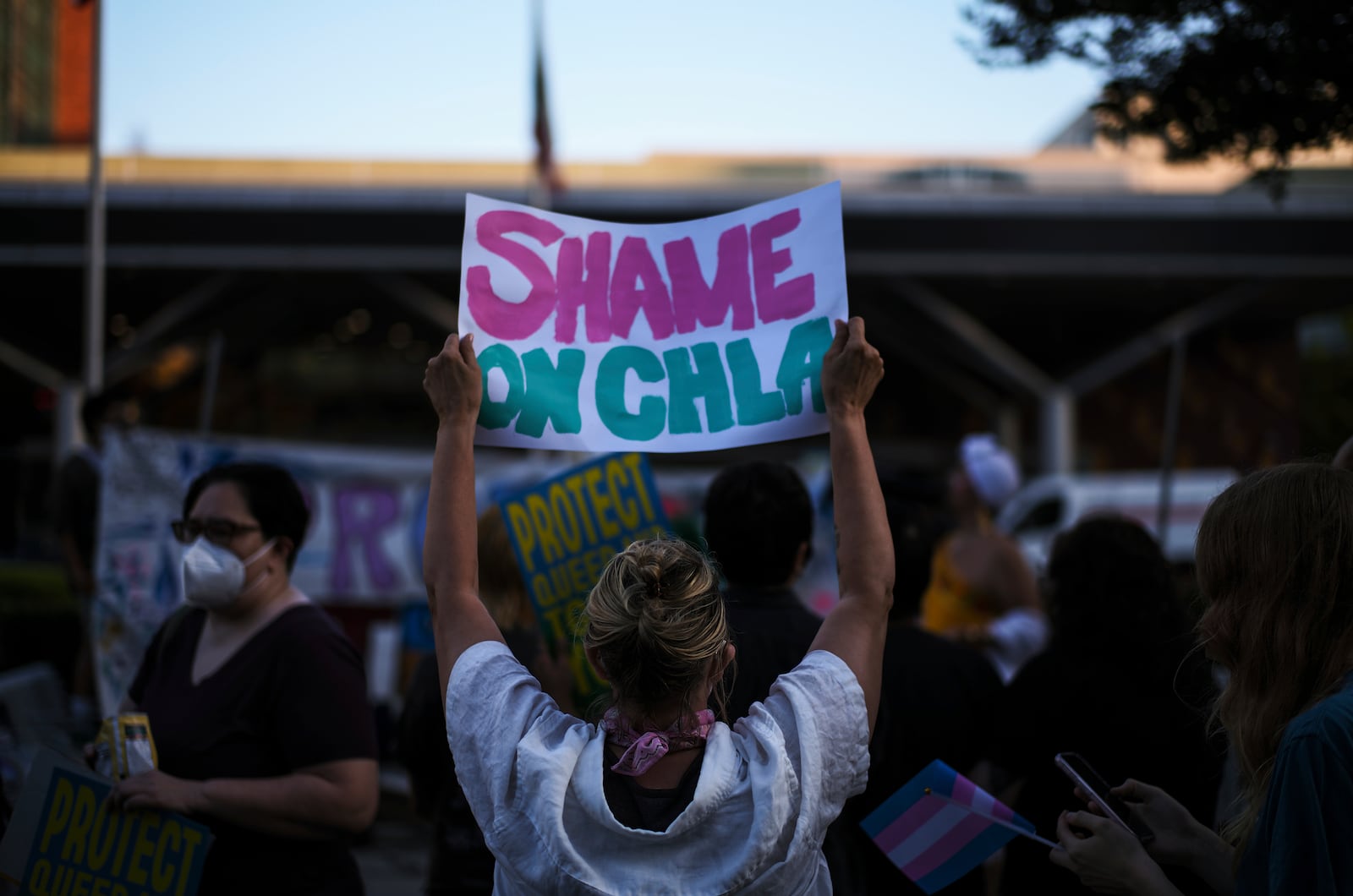 Protesters hold signs while demonstrating against the closure of the trans youth clinic at Children's Hospital Los Angeles, Thursday, July 3, 2025, in Los Angeles. (AP Photo/Jae C. Hong)