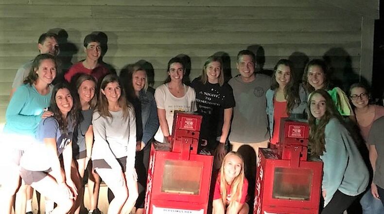 Members of the Miami University Student United Way pose with the Blessing Boxes they established to help provide food to local residents. Similar to the Little Free Library with books, the boxes contain non-perishable food items people free to take if they need food and everyone is invited to place items in them to help others. CONTRIBUTED