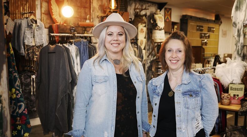 Iron Rose Mercantile and Shades of Chic cabinet painting have opened in a shared space in a renovated building on Ohio 122 in Madison Township. Lisa Dethlefs, left, runs Iron Rose with an eclectic mix of decor, furniture, clothing, gifts, hats, jewelry and more and Susan Cox, right, moved her Shades of Chic business in the back where she paints cabinets for customers. There is a collaborative space for classes, special events and more. NICK GRAHAM/STAFF