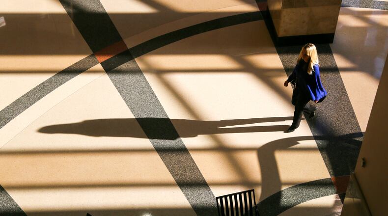 A woman walks through the morning shadows in the Government Services Center. Butler County Commission meets Monday for its annual organizational meeting, and its 2017 includes a full slate of projects — from economic development to tax levies. GREG LYNCH / STAFF