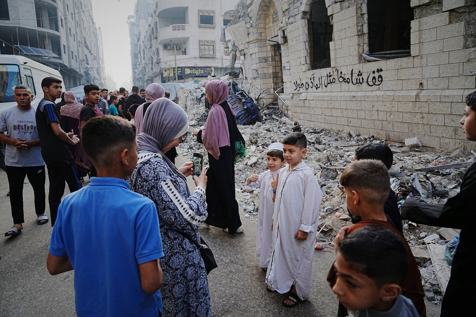 Palestinians gather for Eid al-Adha prayers beside the ruins of Al-Kanz mosque destroyed by Israeli bombardment, in Gaza City on Friday, June 6, 2025. (AP Photo/Jehad Alshrafi)