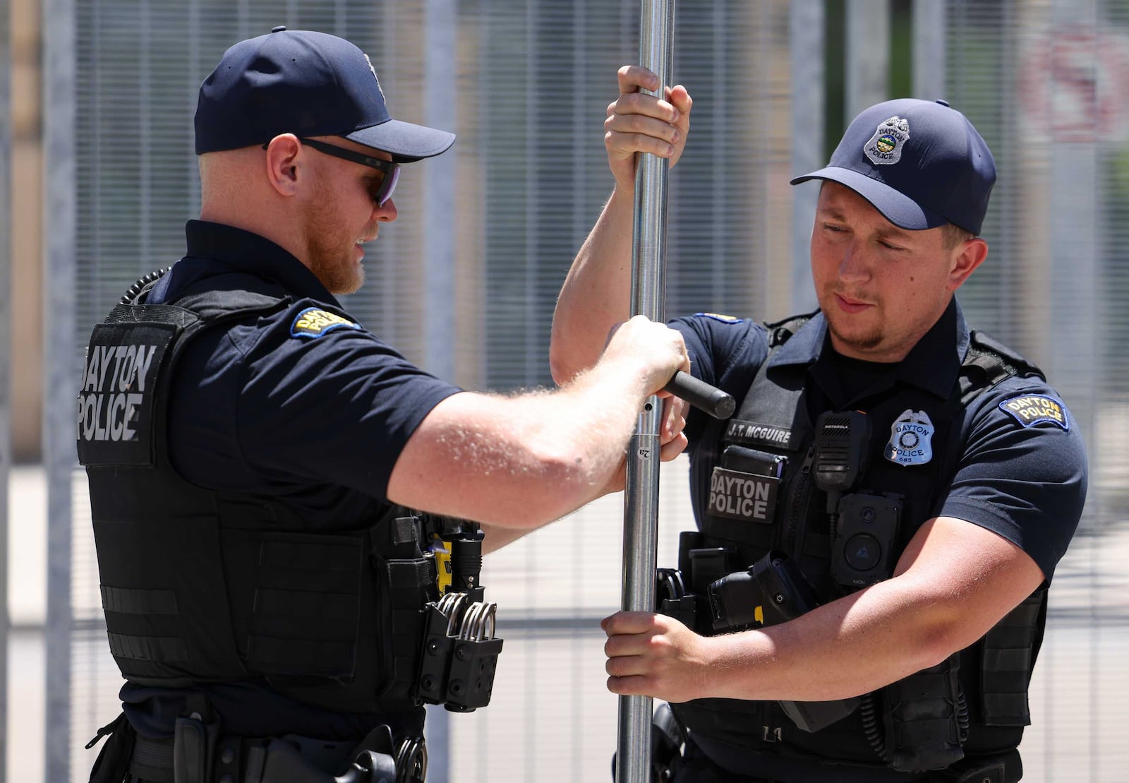Law enforcement takes down the fencing surrounding the NATO Parliamentary Assembly in Dayton, Monday, May 26, 2025.  BRYANT BILLING/STAFF