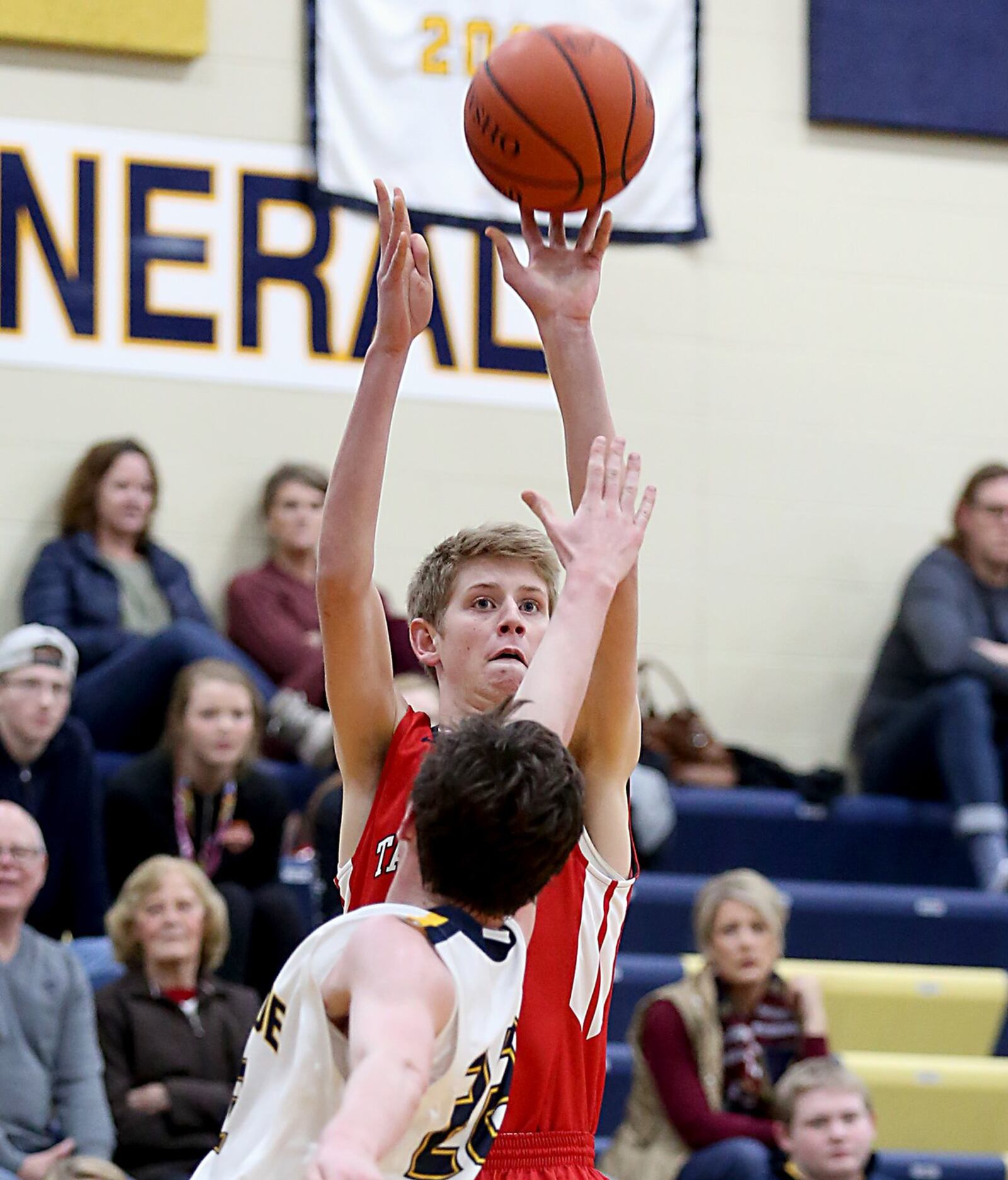 Talawanda’s Josh DeWitt hits a 3-pointer over Monroe guard Tucker Triplett during Tuesday night’s game at Monroe. CONTRIBUTED PHOTO BY E.L. HUBBARD