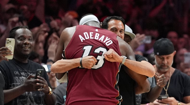 Miami Heat head coach Erik Spoelstra hugs center Bam Adebayo (13) as he leaves the game after scoring 83 points, the second-highest single game total in NBA history, in the second half of an NBA basketball game against the Washington Wizards, Tuesday, March 10, 2026, in Miami. (AP Photo/Rebecca Blackwell)