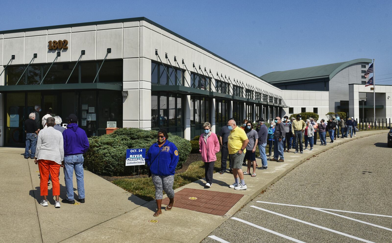 Voters line up at the Butler County Board of Elections on the first day of early voting Tuesday, October 6, 2020 in Hamilton. NICK GRAHAM / STAFF