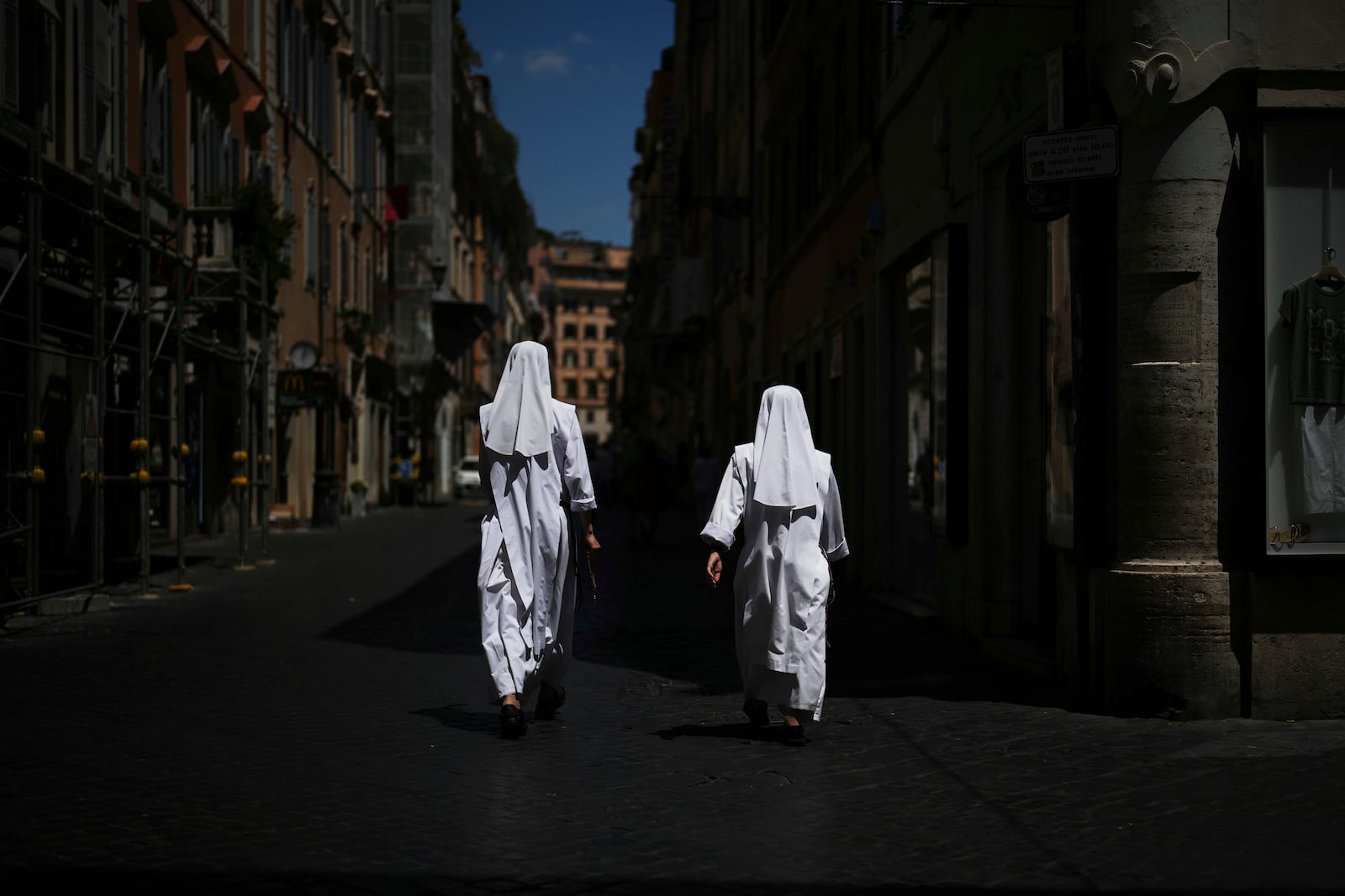 Two nuns walk in a street in downtown Rome, Tuesday, July 1, 2025. (AP Photo/Andrew Medichini)