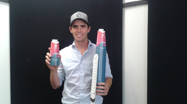 Scott Edwards of Drop Water, a participant in the Pipeline H2O program, shows containers used by his water-dispensing machines that sell the liquid in a more environmentally friendly way. MIKE RUTLEDGE/STAFF