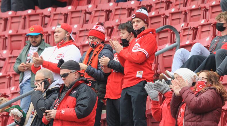 Reds fans cheer during a pregame ceremony on Opening Day on Thursday, April 1, 2021, at Great American Ball Park in Cincinnati. David Jablonski/Staff