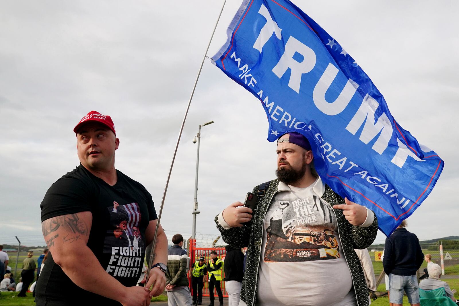 People gather outside the airport in Prestwick, South Ayrshire, Scotland, on Friday, July 25, 2025, ahead of the arrival of U.S. President Donald Trump. (Jane Barlow/PA via AP)