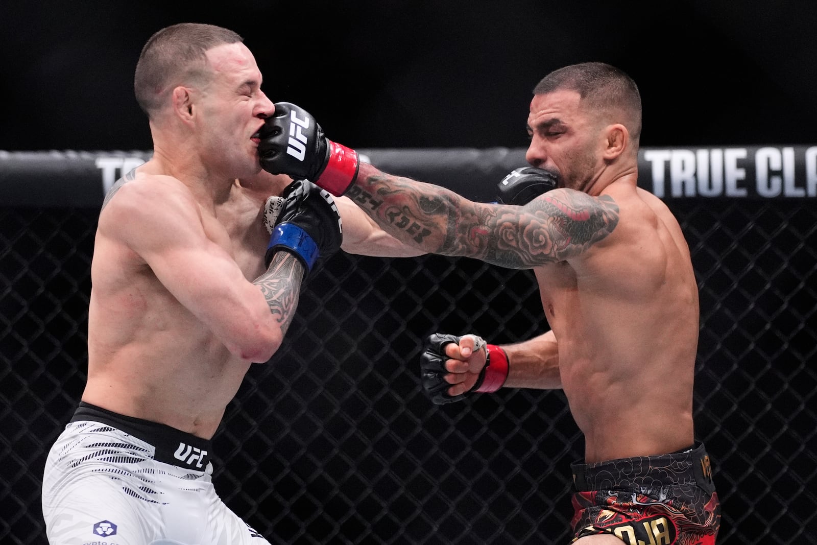 Alexandre Pantoja, right, and Kai Kara-France exchange blows in a flyweight title fight at UFC 317, Saturday, June 28, 2025, in Las Vegas. (AP Photo/John Locher)