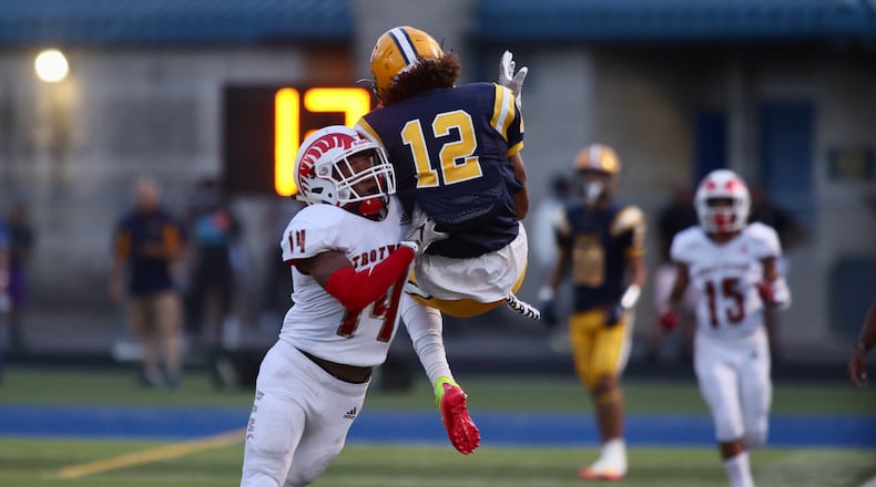 Springfield Da'Shawn Martin is hit by Trotwood-Madison's Marlon Howard Jr. on Friday, Sept. 2, 2022, in Springfield. David Jablonski/Staff