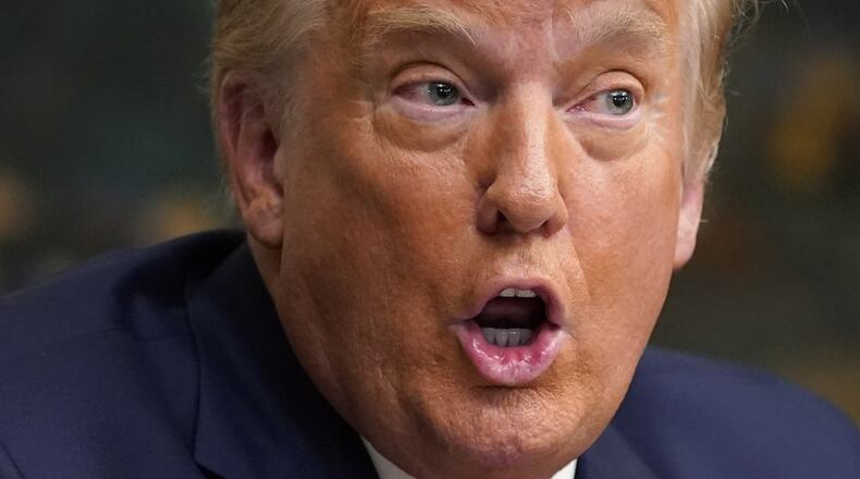 President Donald Trump speaks with reporters after participating in a video teleconference call with members of the military on Thanksgiving, Thursday, Nov. 26, 2020, at the White House in Washington. (AP Photo/Patrick Semansky)