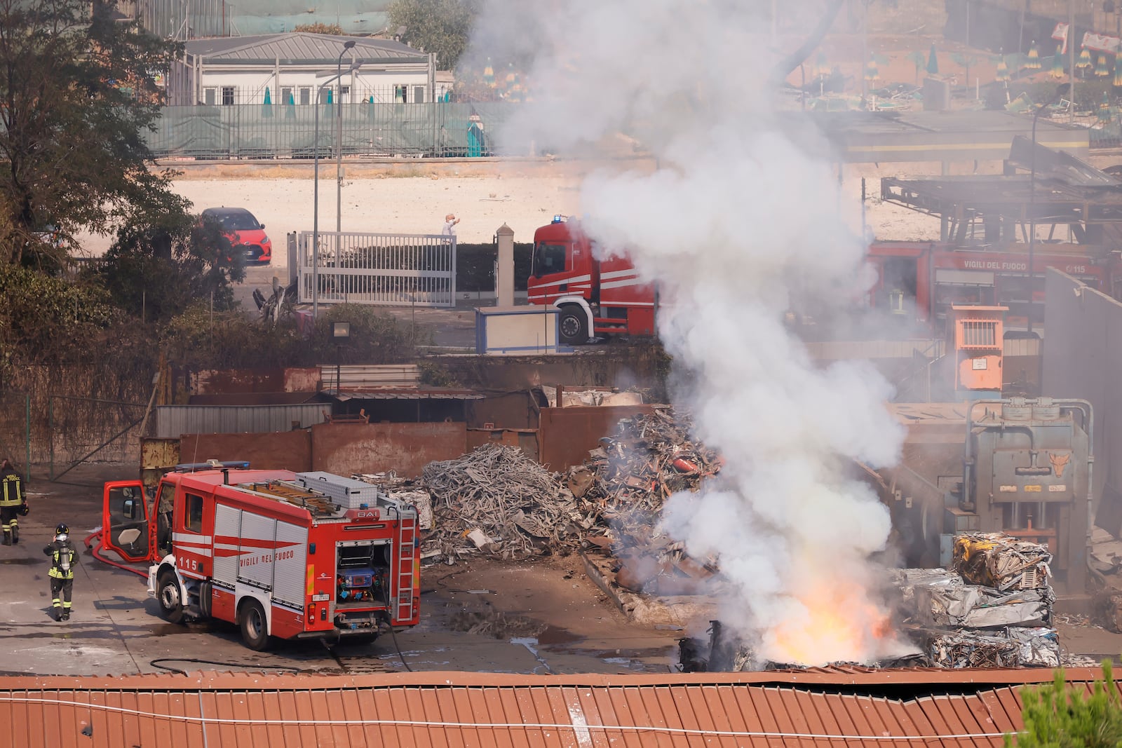 Firefighters monitor the area where a gas station exploded on the outskirts of Rome, Friday, July 4, 2025. (Cecilia Fabiano/LaPresse via AP)