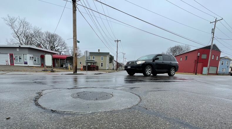 The city of Hamilton since 2019 has been strengthening its manhole covers to provide a longer lasting street surfaces. MICHAEL D. PITMAN/STAFF