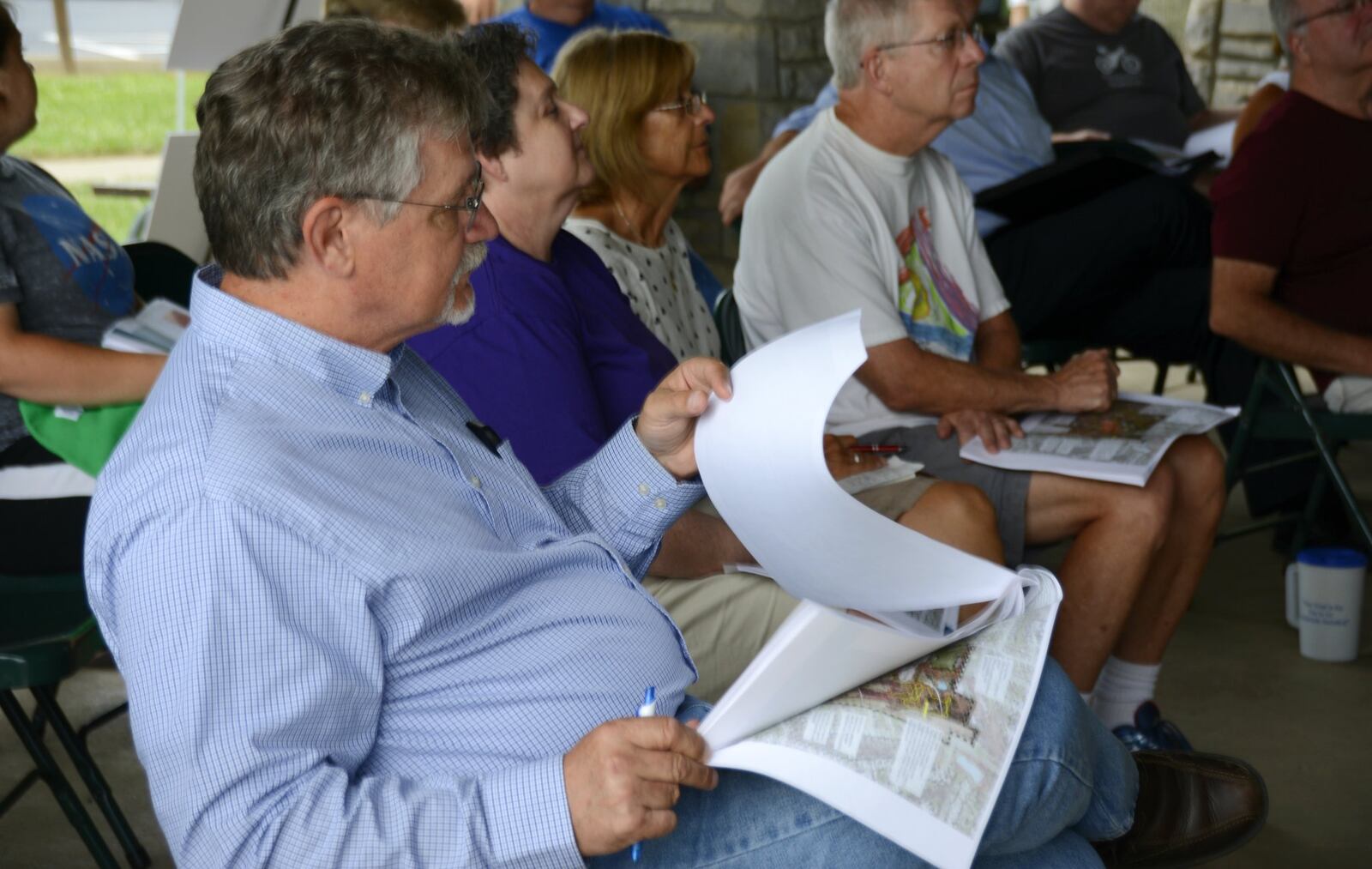Dean Bruewer, of Fairfield, listens to a representative with architect Brandstetter Carroll, Inc. on Tuesday as they talk about three concept plans for Harbin Park. About three dozen people attended a public forum where people were asked to share their thoughts and opinions about the ideas, tell city officials and architects what they want to see in the park, and ask questions.