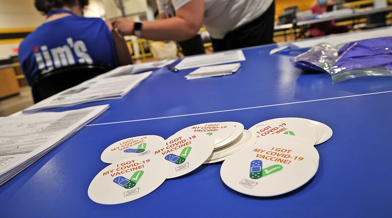 A pile of "I Got My COVID-19 Vaccine!" stickers waits for students and adults to get their vaccine shot Monday at a vaccine clinic at Shawnee High School.