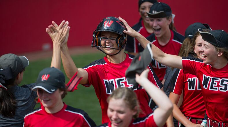 Lakota West’s Allie Cummins celebrates with her teammates after hitting a solo home run in the top of the eighth inning May 31 at Firestone Stadium in Akron. The homer gave the Firebirds a 2-1 win over Perrysburg in a Division I state semifinal. CONTRIBUTED PHOTO BY PHIL LONG