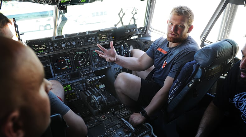 Cincinnati Bengals fourth-round draft pick Cordell Volson sits in the pilot seat of a C-17 aircraft at the 445th Airlift Wing at Wright-Patterson Air Force Base Friday on June 3, 2022. MARSHALL GORBY\STAFF