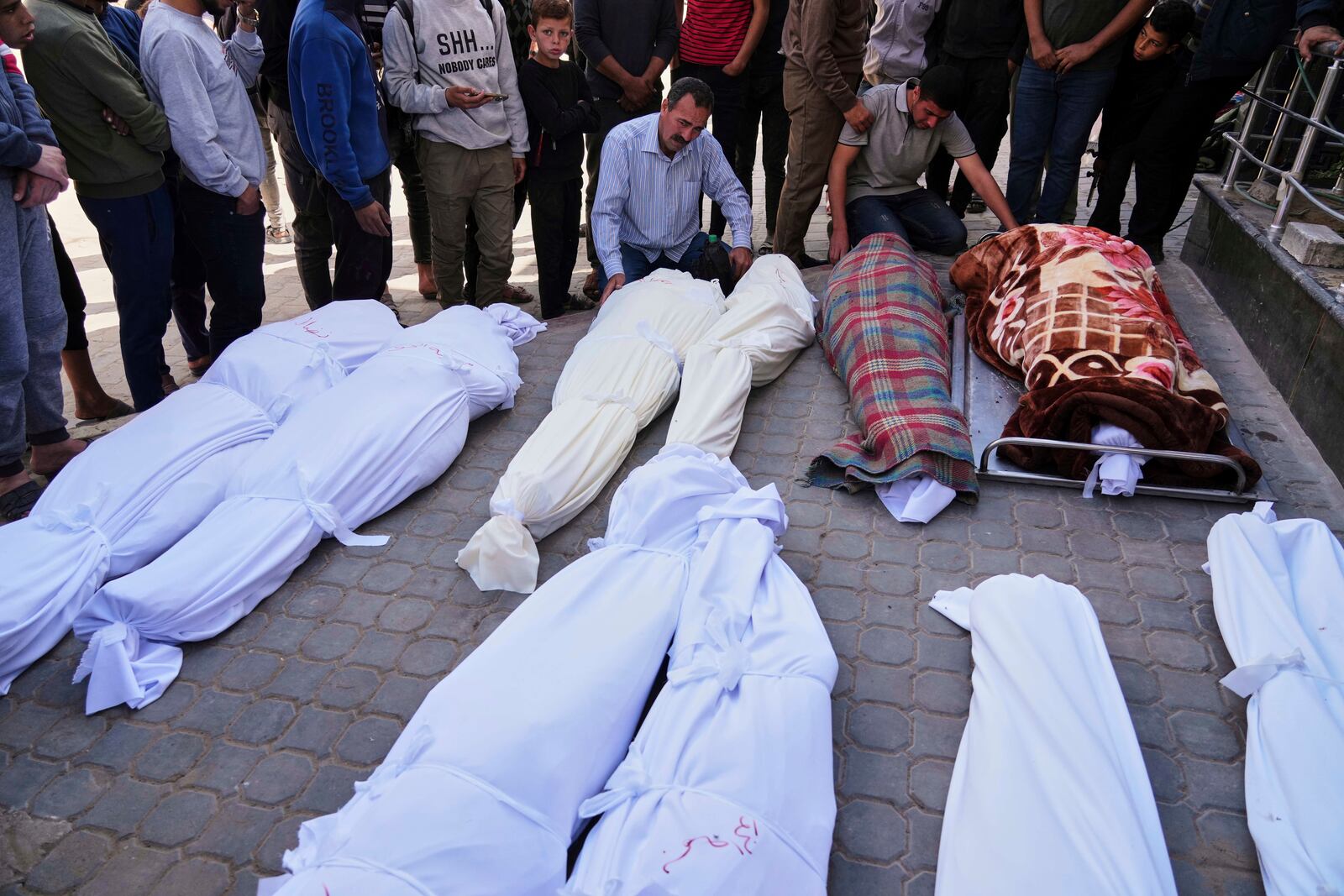 Palestinians mourn over the bodies of their relatives who were killed in an Israeli airstrike, as they brought to Shifa Hospital in Gaza City, on Saturday, April 26, 2025. (AP Photo/Jehad Alshrafi)