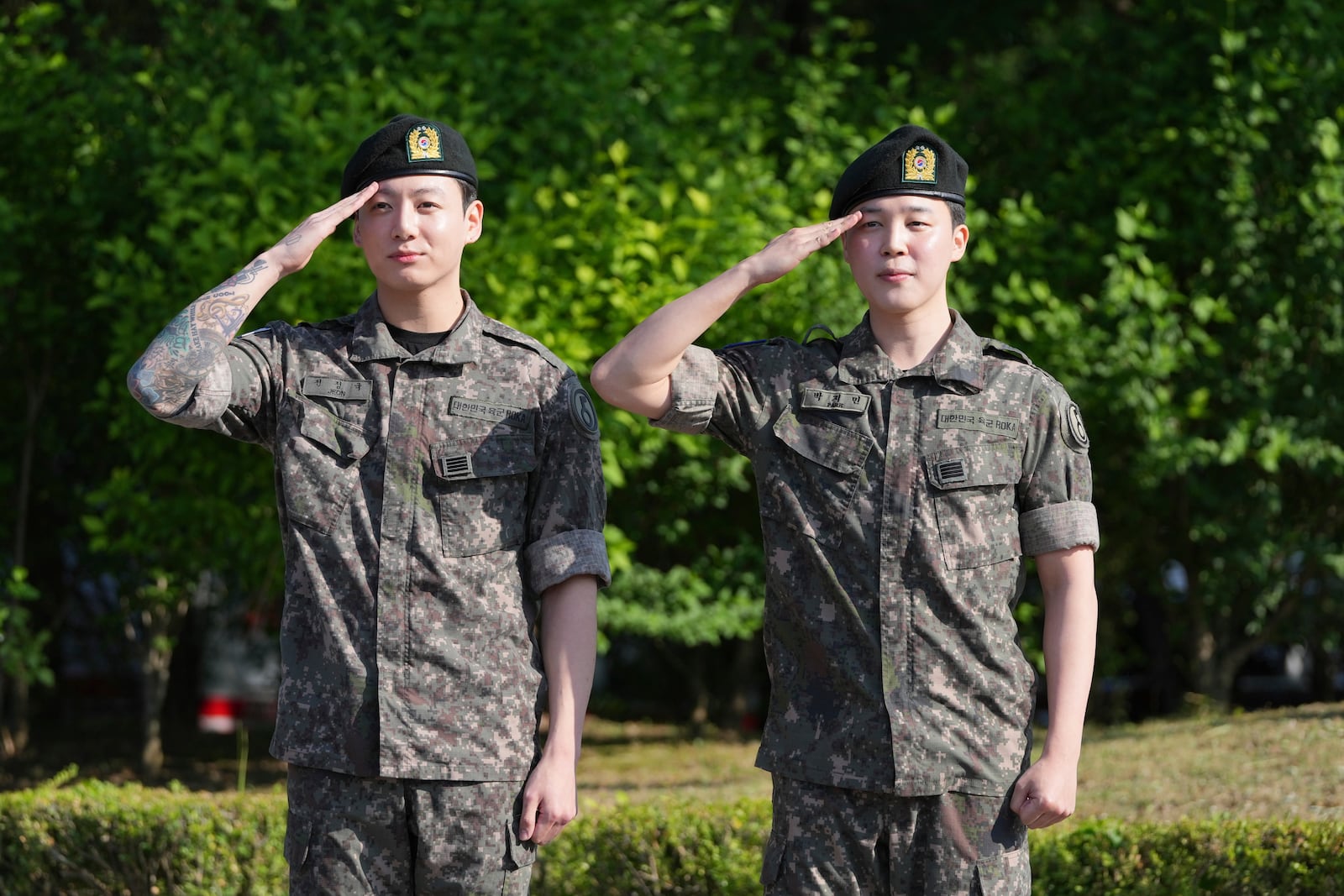 K-pop band BTS members Jimin, right, and Jung Kook salute after being discharged from a mandatory military service in Yeoncheon, South Korea, Wednesday, June 11, 2025. (AP Photo/Lee Jin-man)
